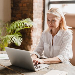 Tutor teacher working typing on laptop, searching information, social media surfing online in office